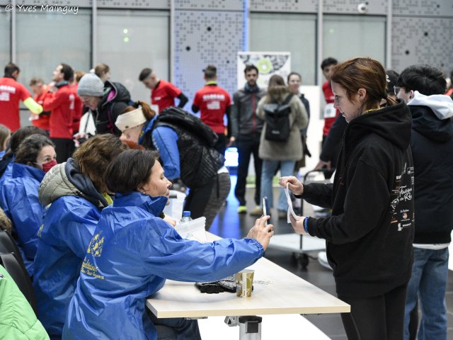 Le comptoir de retrait des dossards, bénévoles d'un côté, coureurs de l'autre.